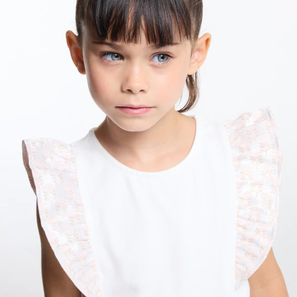 Girl's ecru top with ruffled cap sleeves