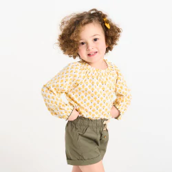 Baby girl's yellow blouse with graphic motifs