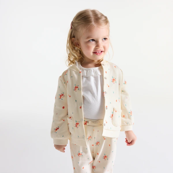جاكيت من طراز تيدي من الميلتون برسوم الأزهار،  باللون البيج للفتيات الصغيرات جاكيت من طراز تيدي من الميلتون برسوم الأزهار،  باللون البيج للفتيات الصغيرات